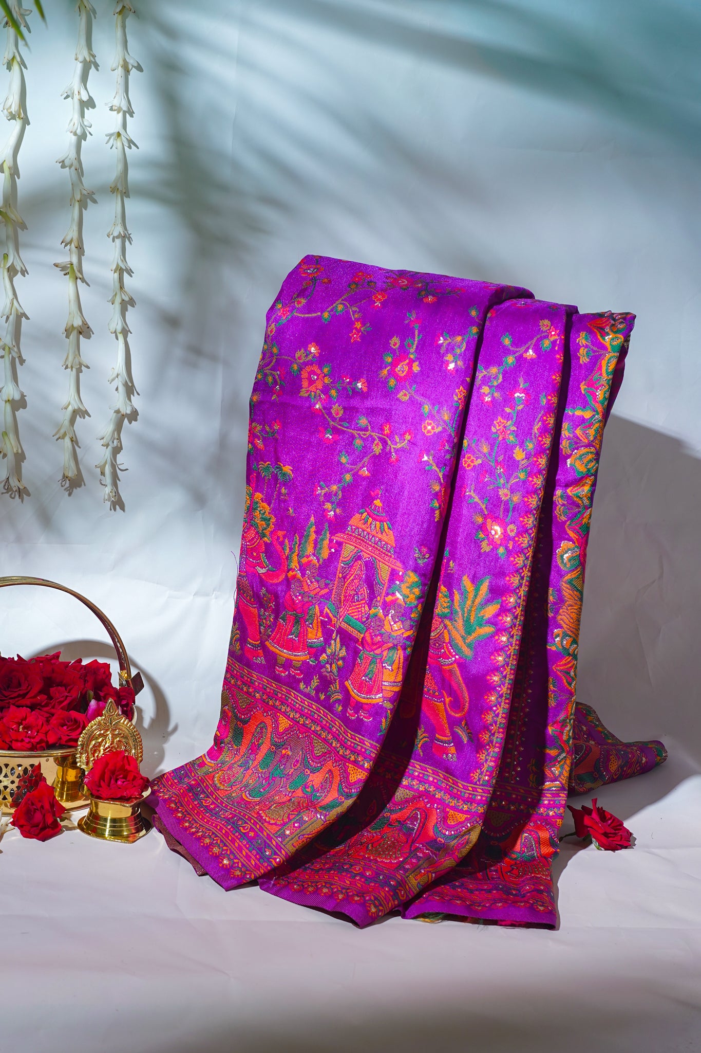 Colorful saree with intricate patterns on a white surface