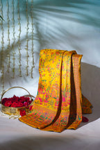 Yellow floral saree with a basket of red flowers on a white background