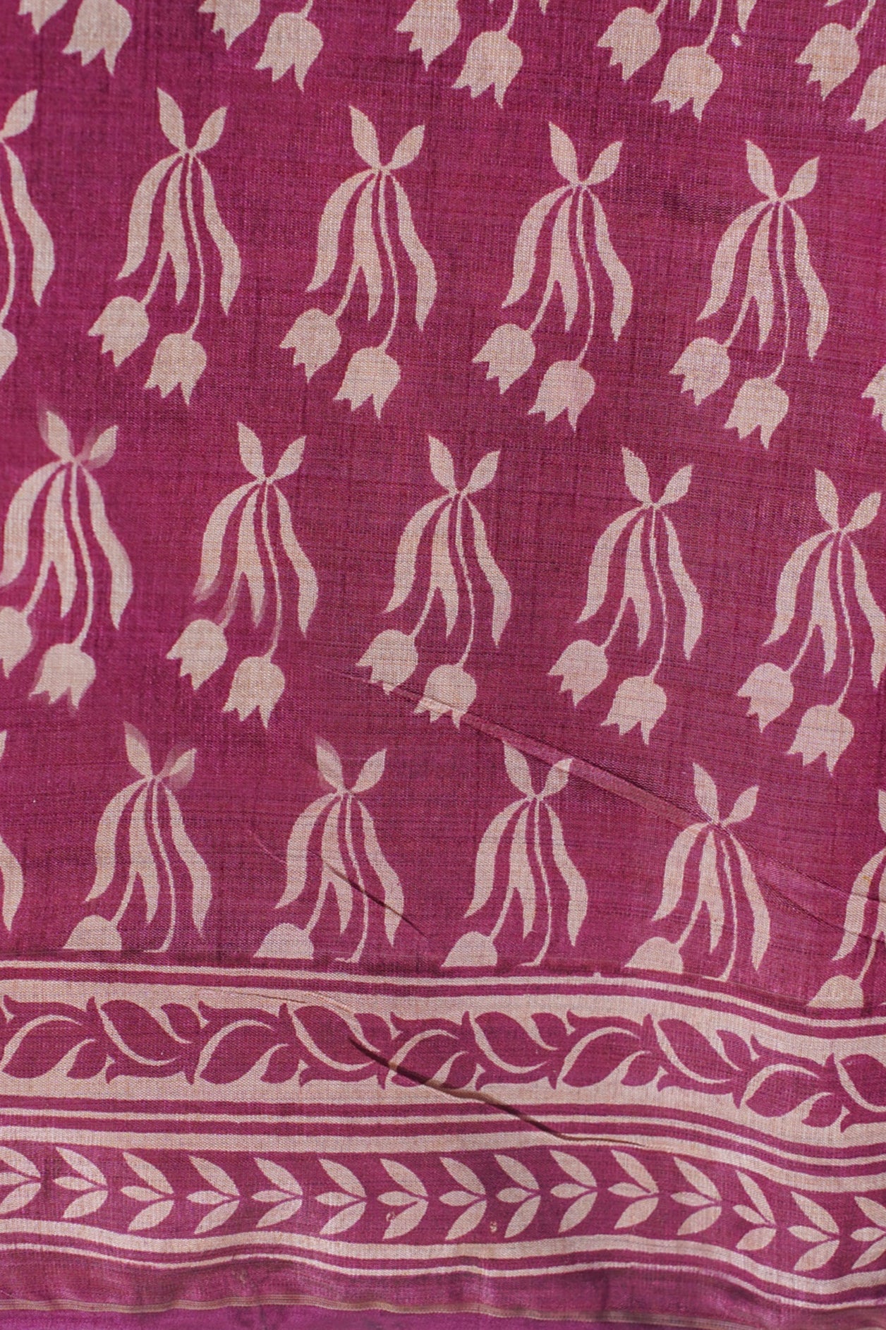 Pink fabric with white floral pattern on a white background