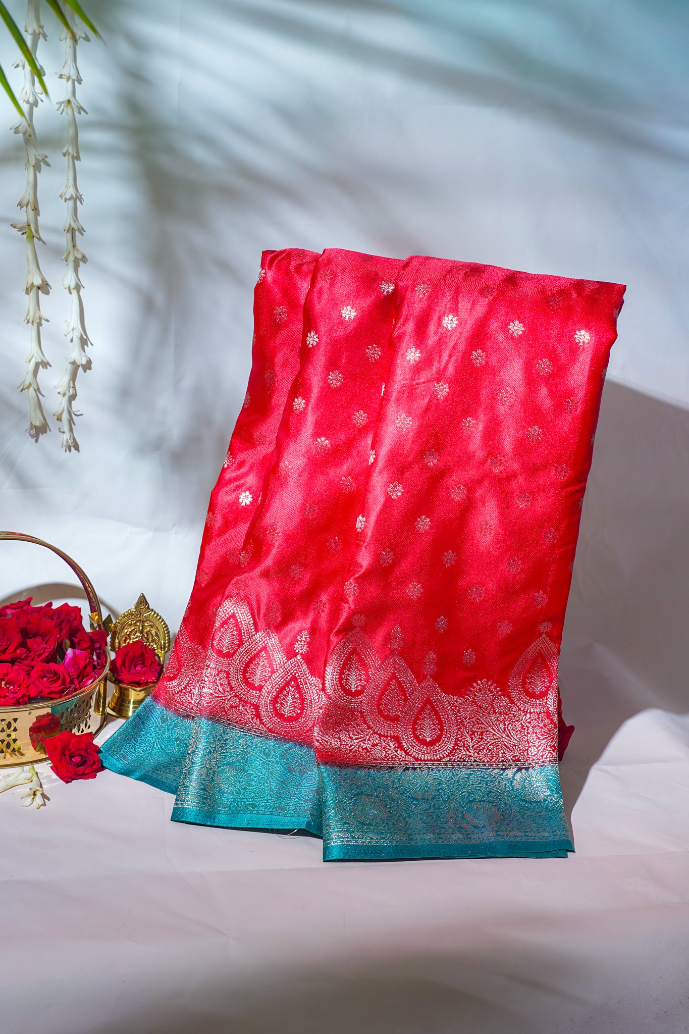 Red saree with blue border on a white background
