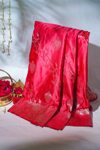 Red embroidered fabric with floral patterns on a white background