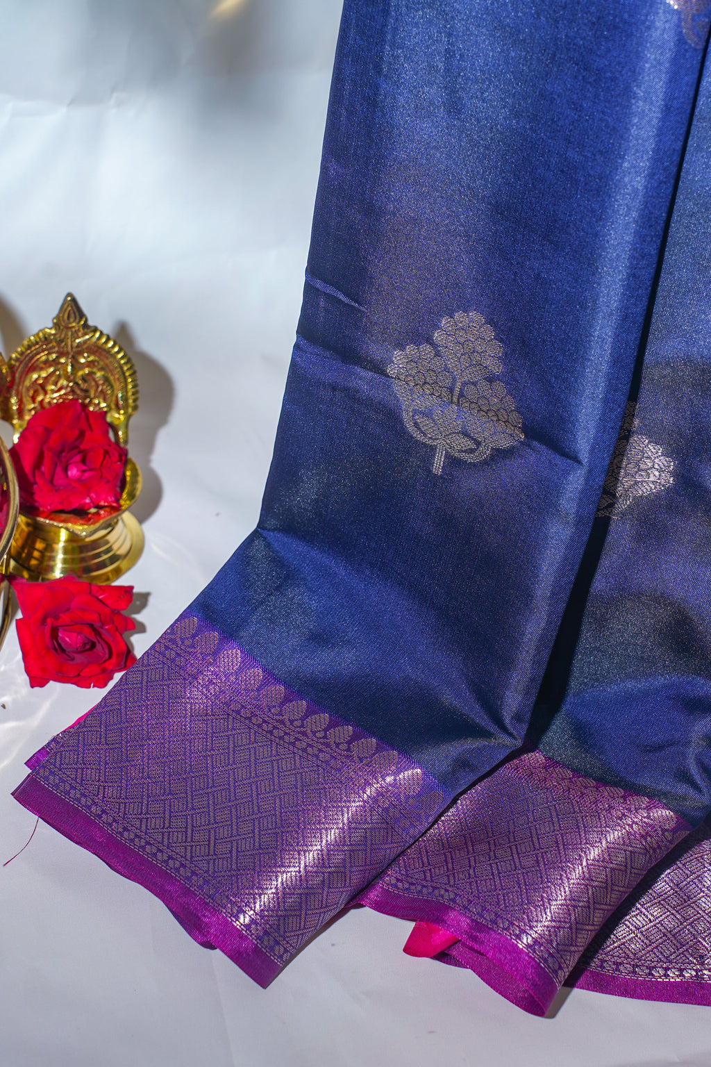 Blue and purple saree with floral patterns on a white background