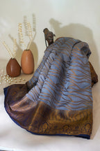 Textured fabric with blue and brown patterns on a white surface
