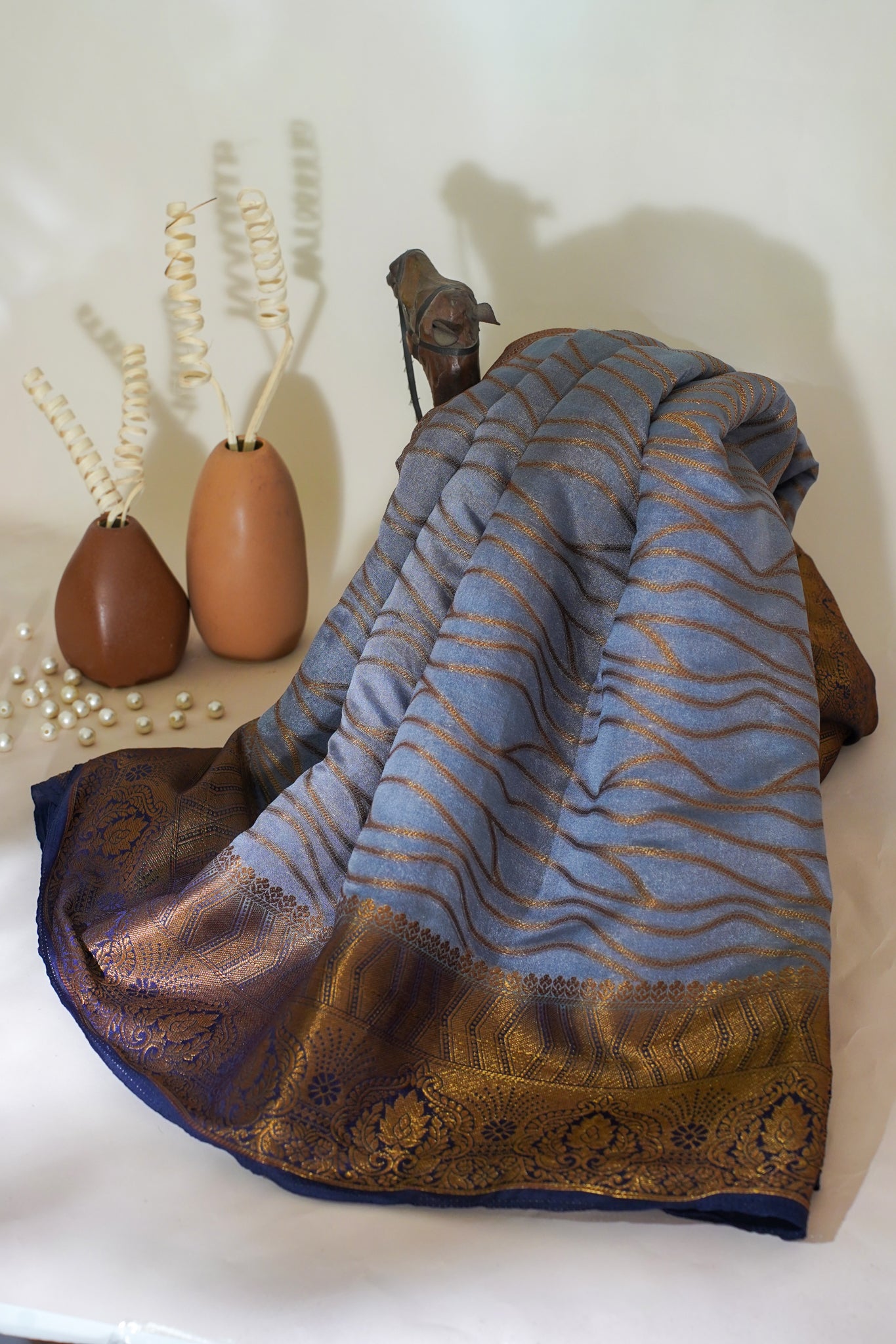 Textured fabric with blue and brown patterns on a white surface