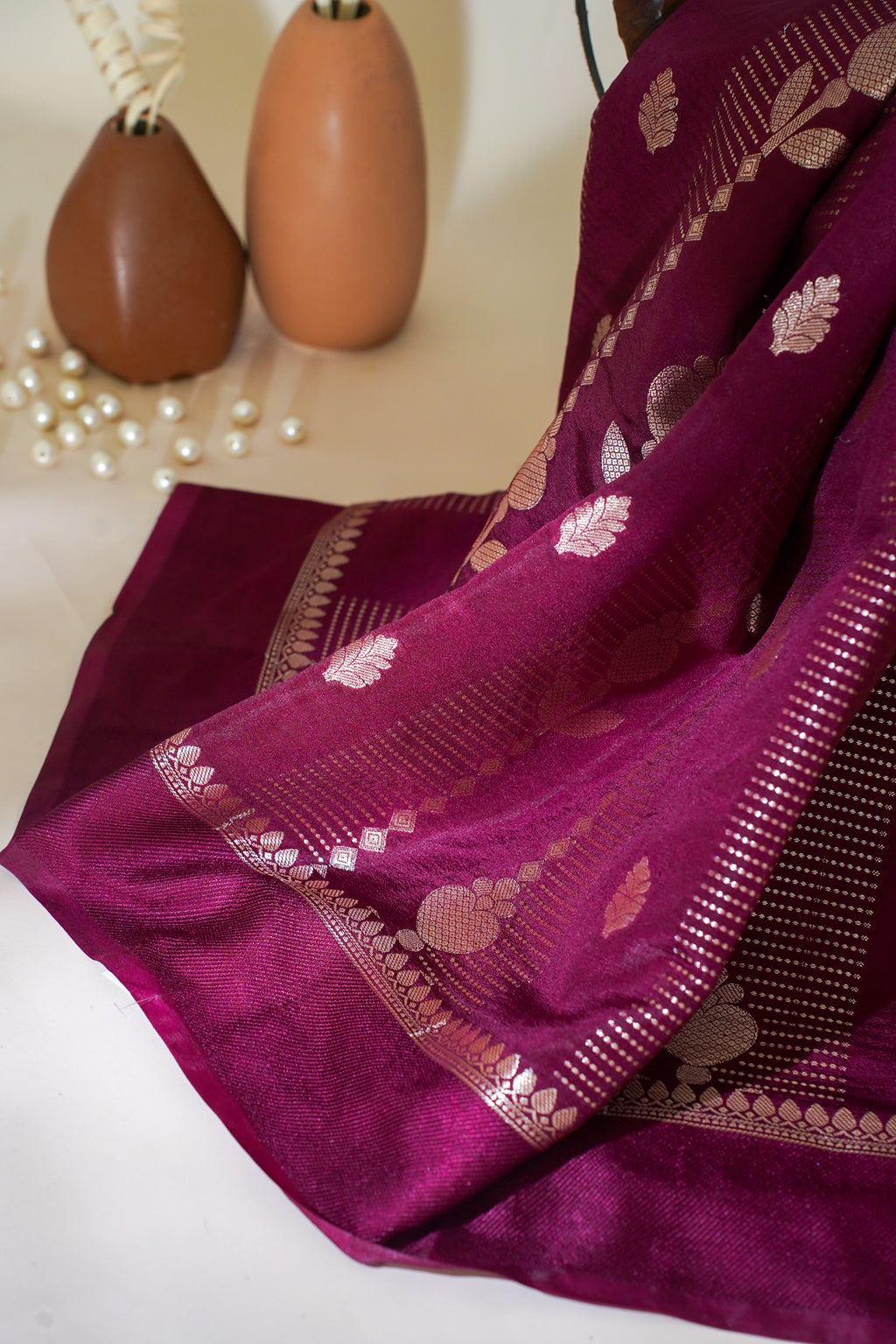 Purple saree with gold patterns on a white background