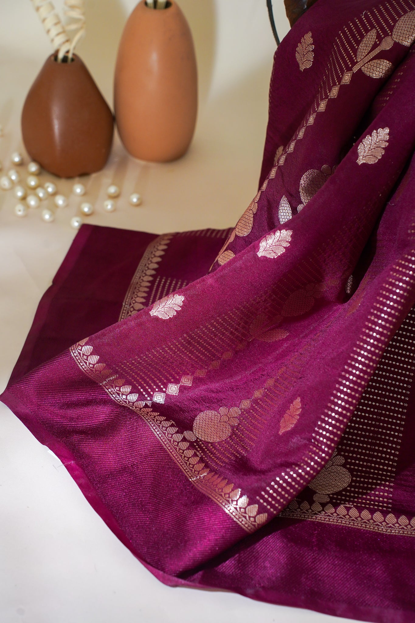 Purple saree with gold patterns on a white background