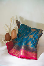 Blue and pink saree with decorative elements on a white surface
