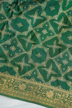 Green fabric with gold floral patterns on a white background