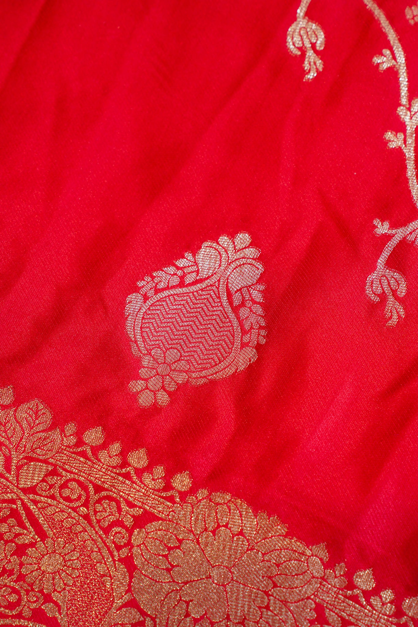 Red fabric with intricate gold embroidery