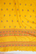 Yellow fabric with floral patterns and colorful borders on a white background