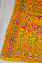 Colorful traditional fabric with intricate patterns on a yellow background