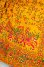 Traditional fabric with colorful patterns and characters on a yellow background