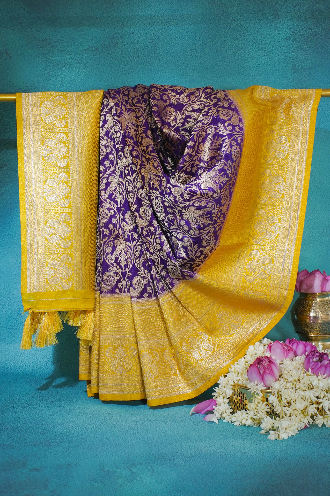 Purple saree with yellow border on a blue background
