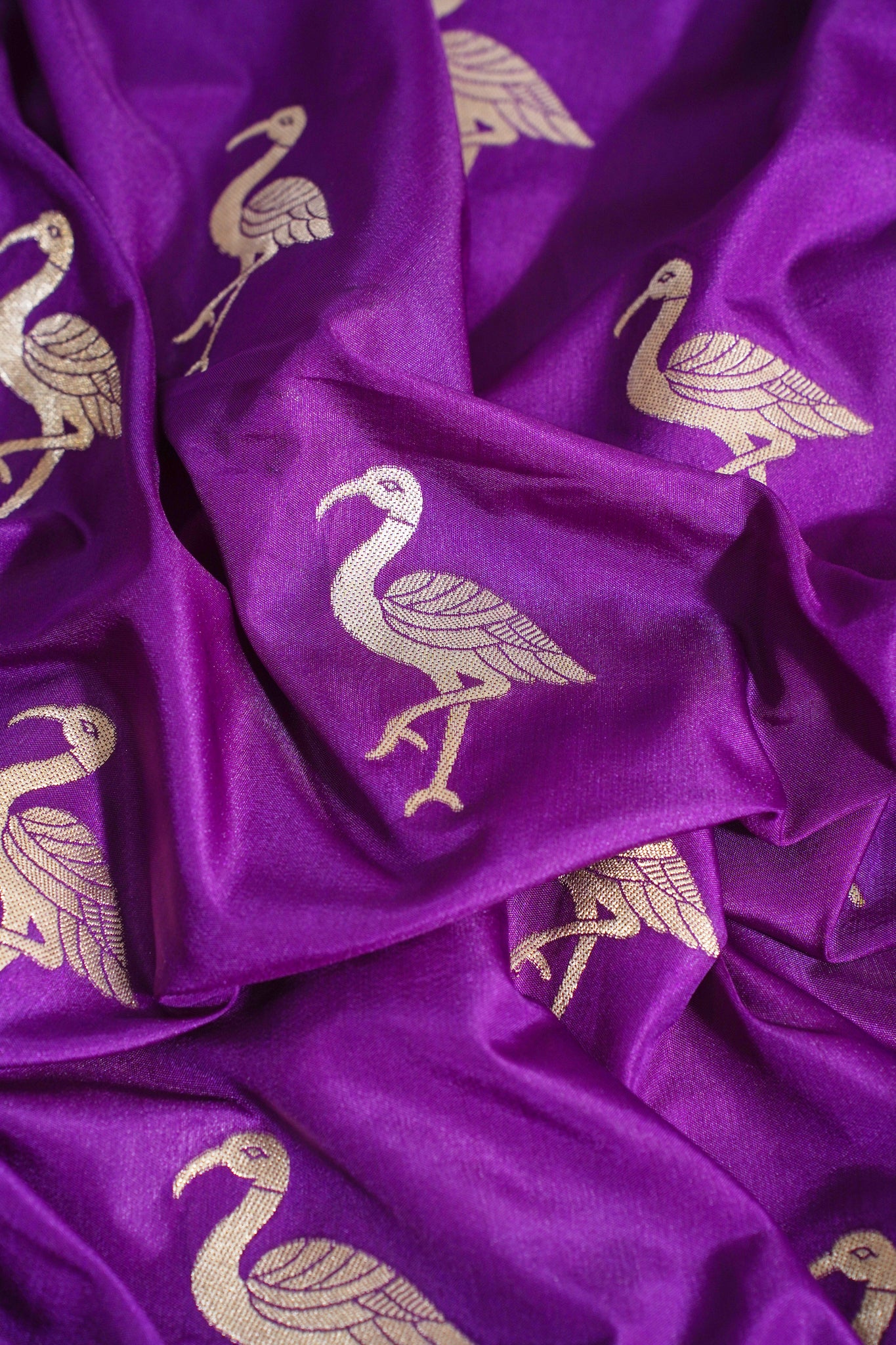 Purple fabric with gold bird patterns