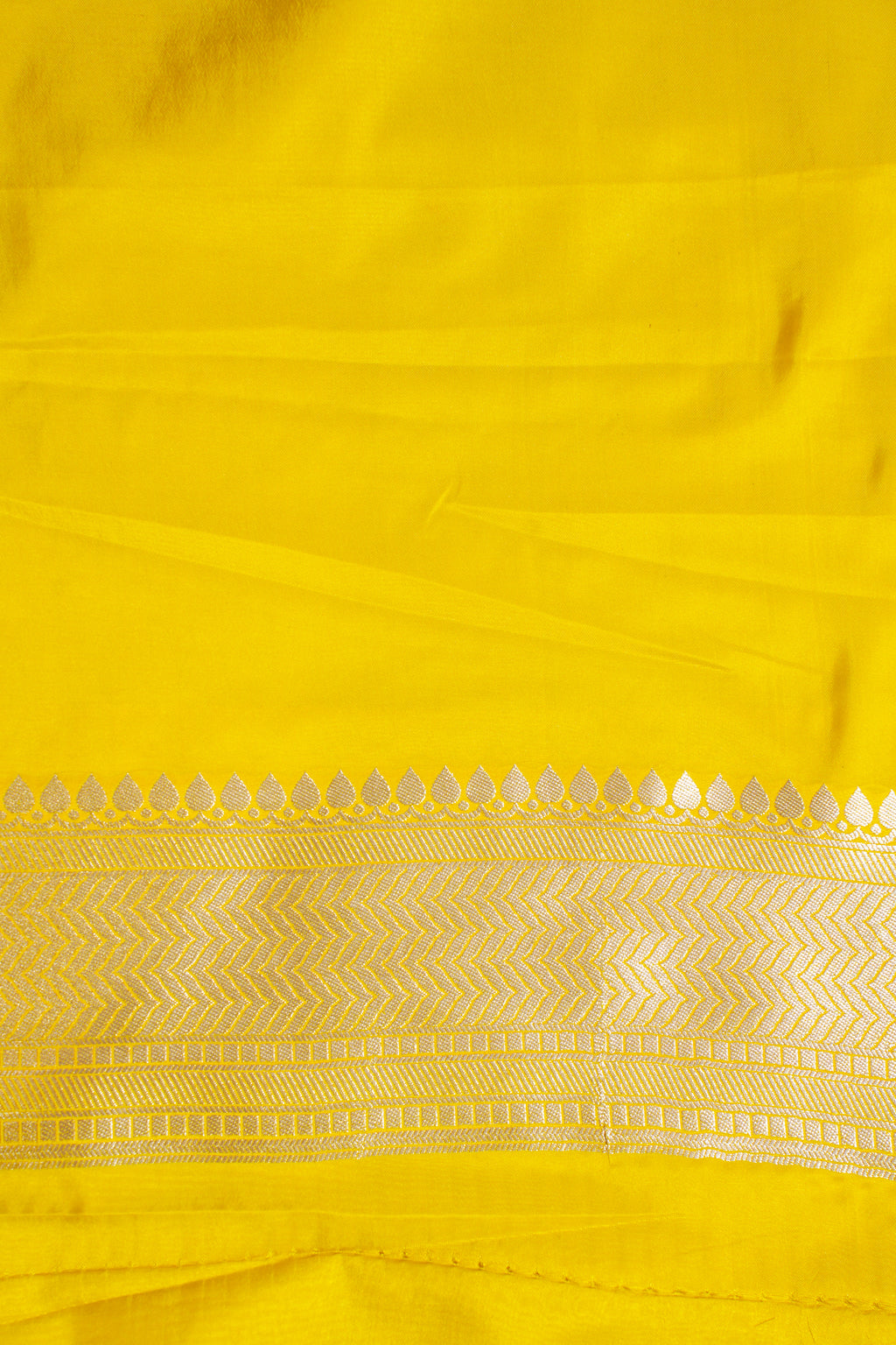 Close-up of a yellow fabric with intricate patterns