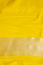 Close-up of a yellow fabric with intricate patterns