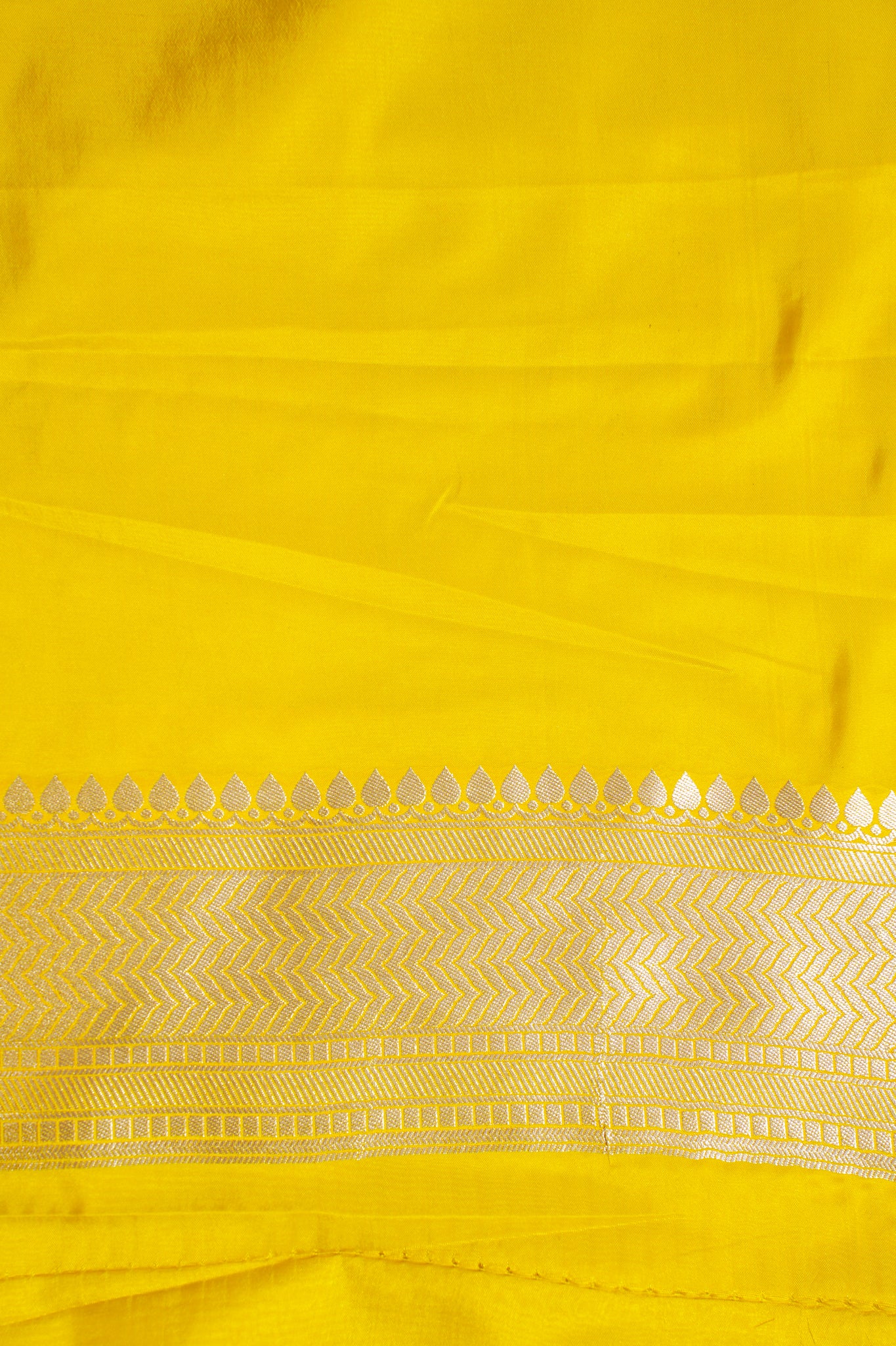 Close-up of a yellow fabric with intricate patterns