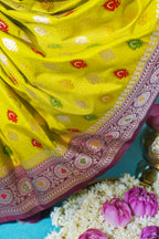 Yellow fabric with intricate patterns on a blue background