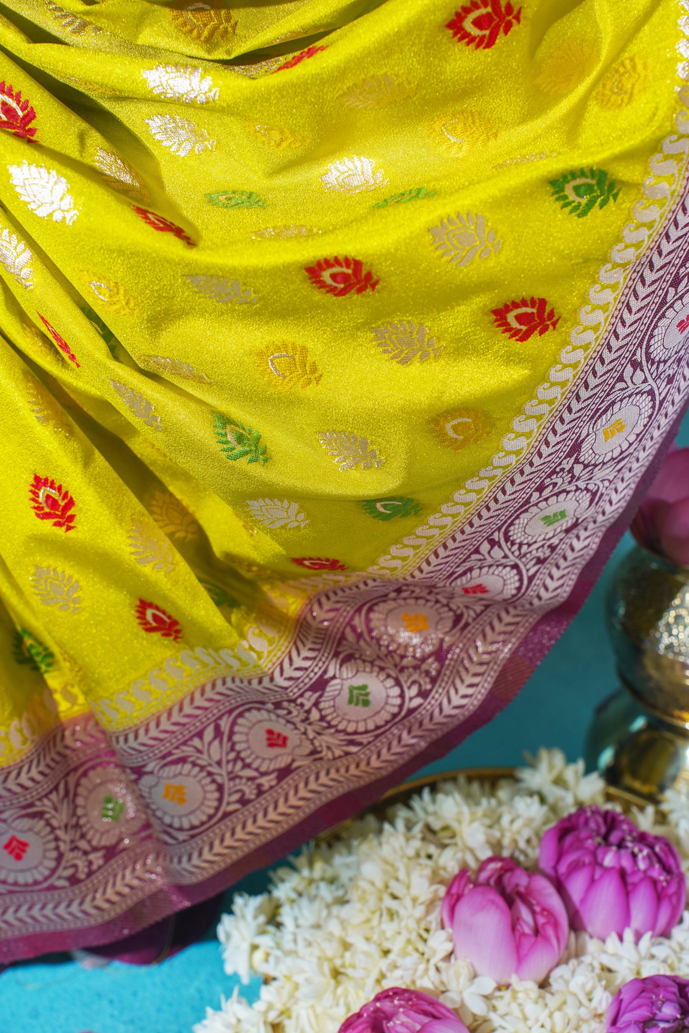 Yellow fabric with intricate patterns on a blue background