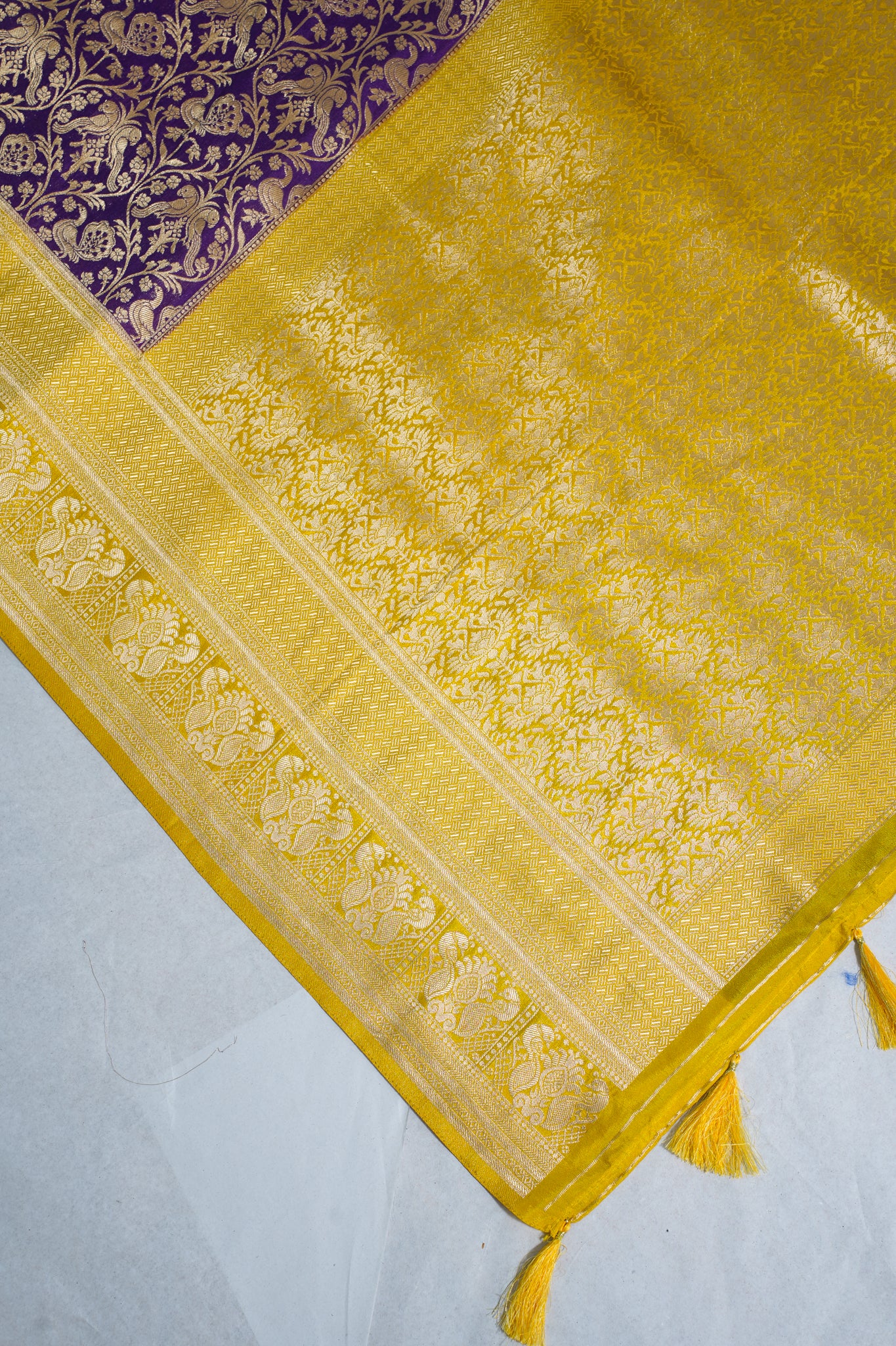 Yellow fabric with intricate patterns on a white background