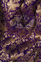 Close-up of purple fabric with gold floral patterns