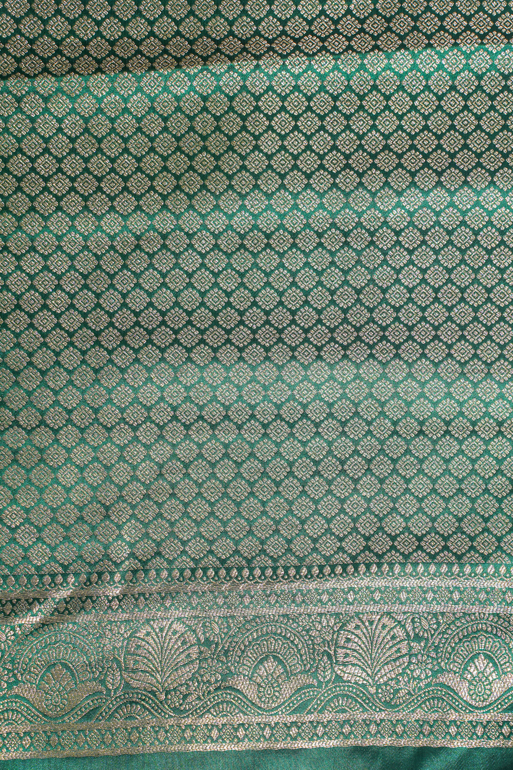 Green fabric with intricate silver patterns