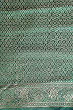Green fabric with intricate silver patterns