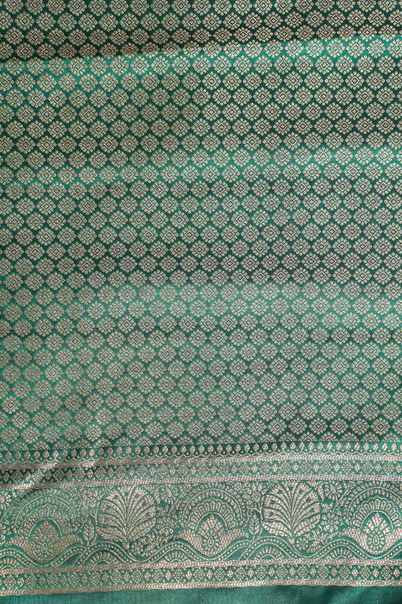 Green fabric with intricate silver patterns