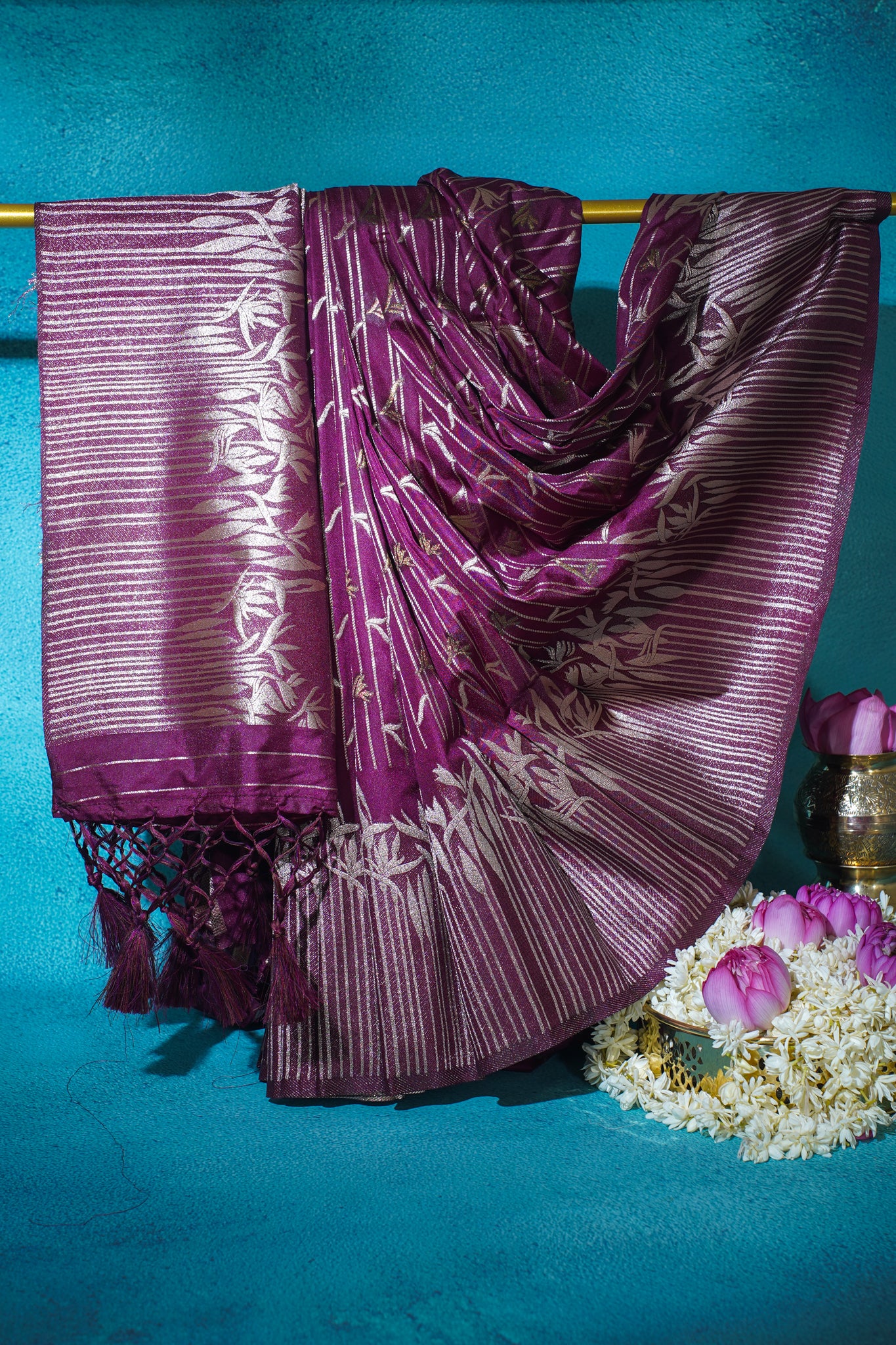 Purple saree with white patterns on a blue background