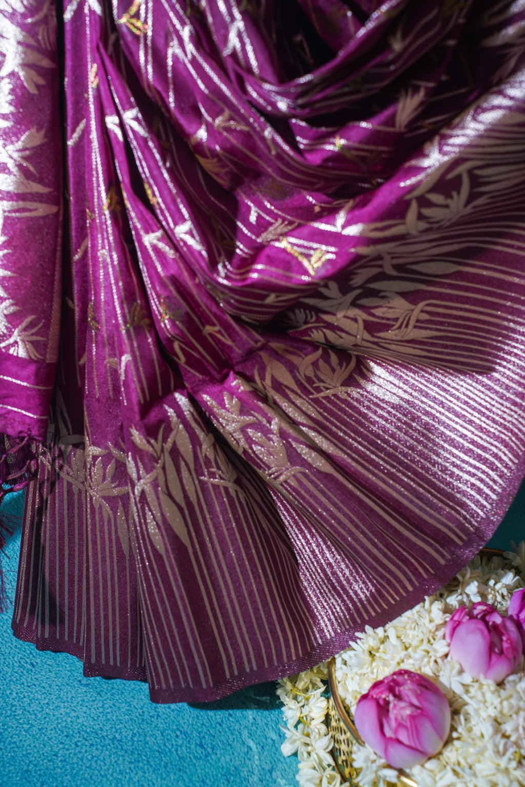 Purple fabric with gold patterns on a blue background
