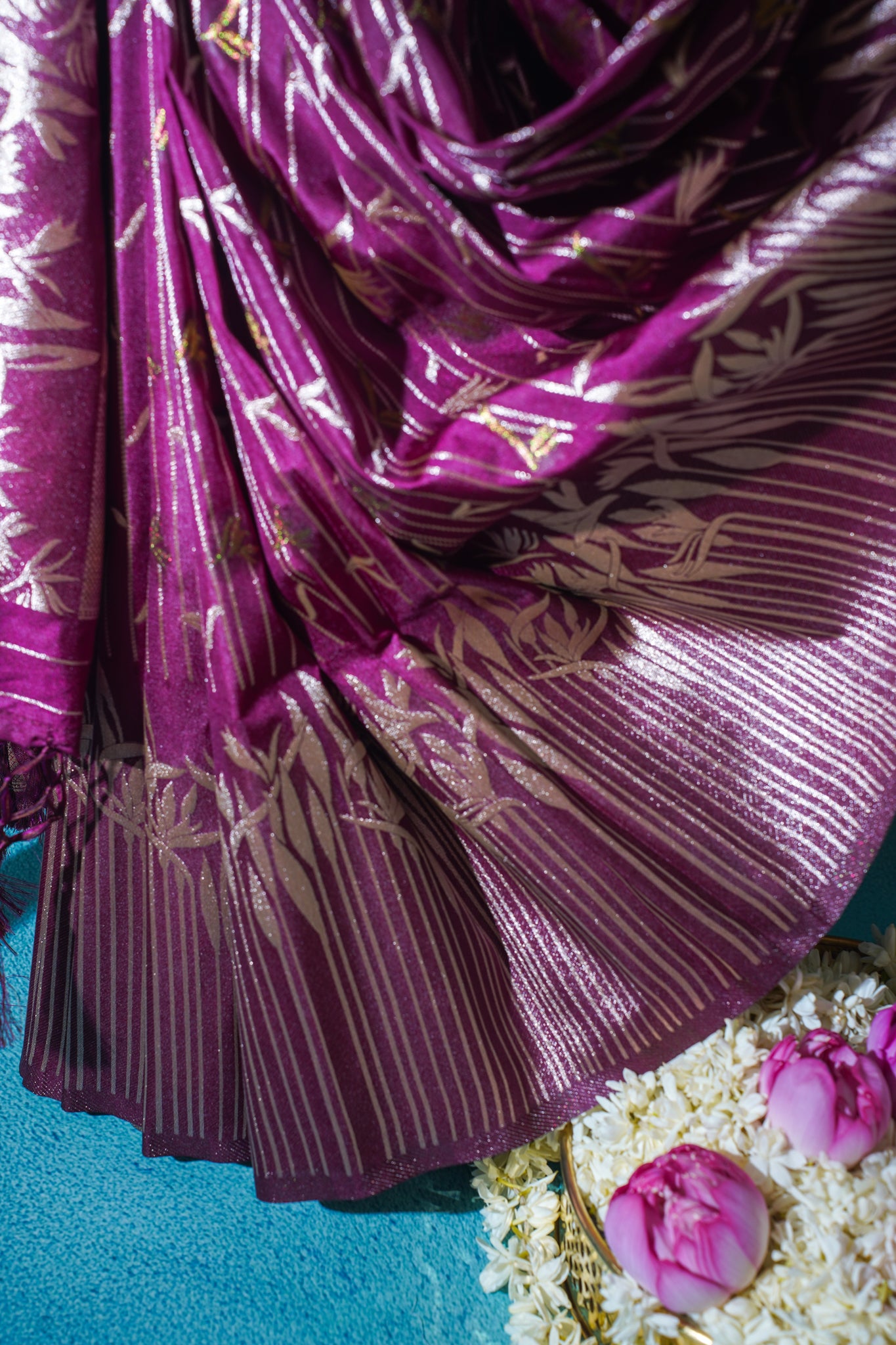 Purple fabric with gold patterns on a blue background
