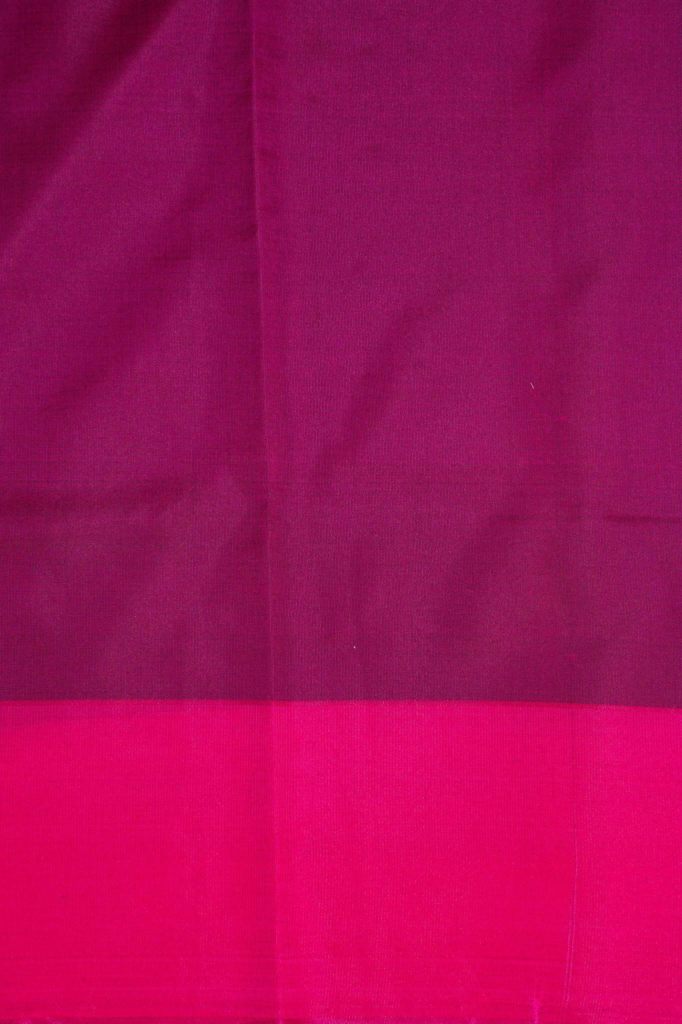 Close-up of pink fabric with a subtle pattern