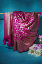 Pink saree with white patterns on a blue background