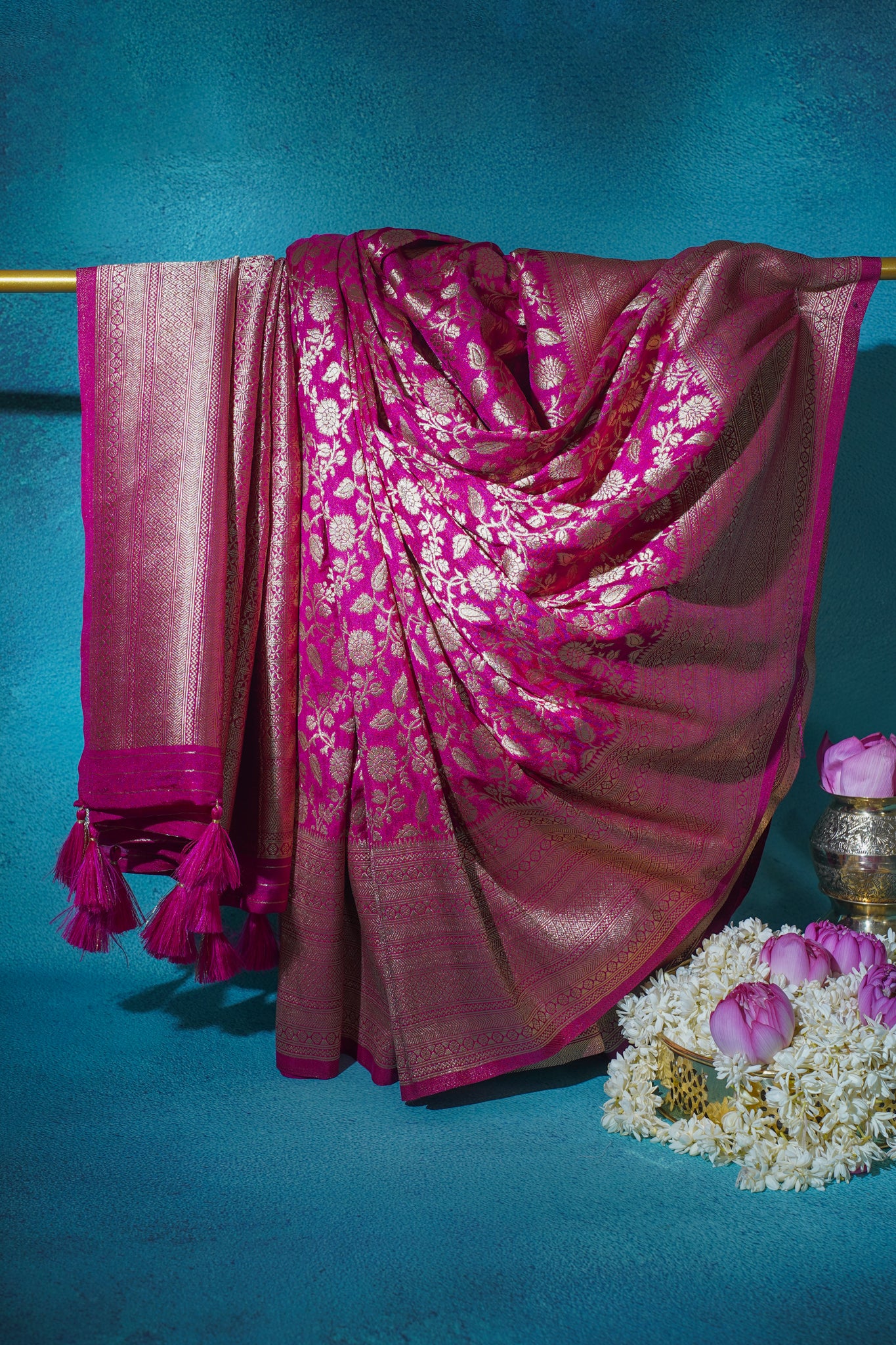 Pink saree with white patterns on a blue background