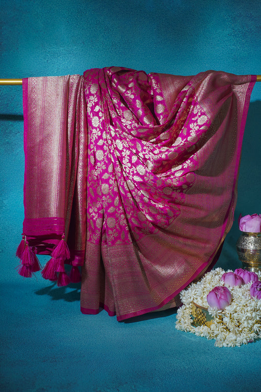 Pink saree with white patterns on a blue background