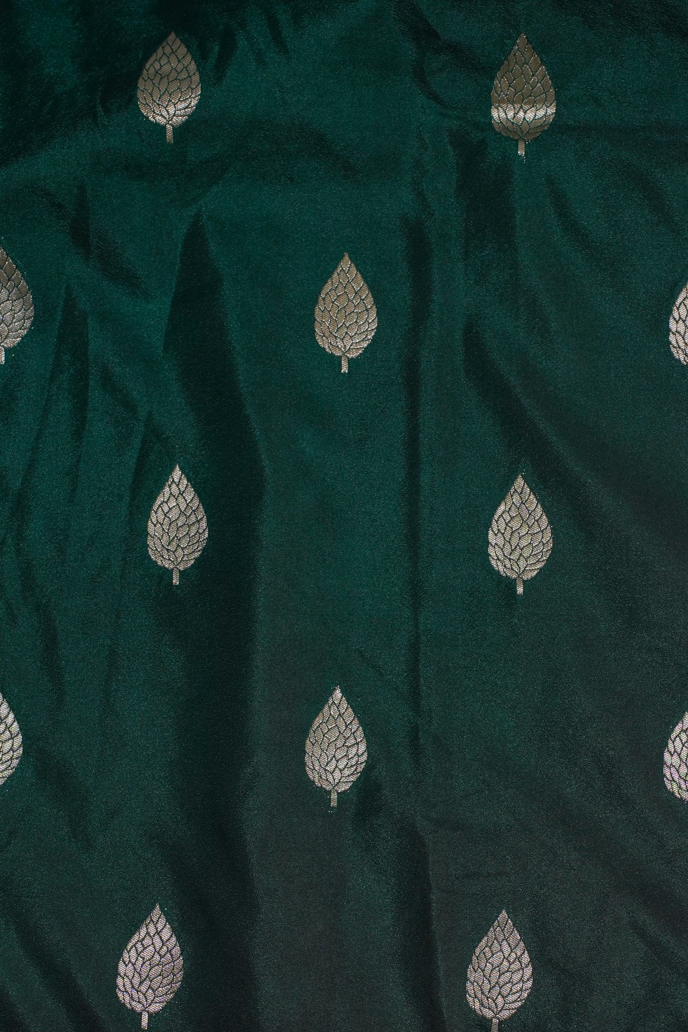Dark green fabric with silver leaf patterns
