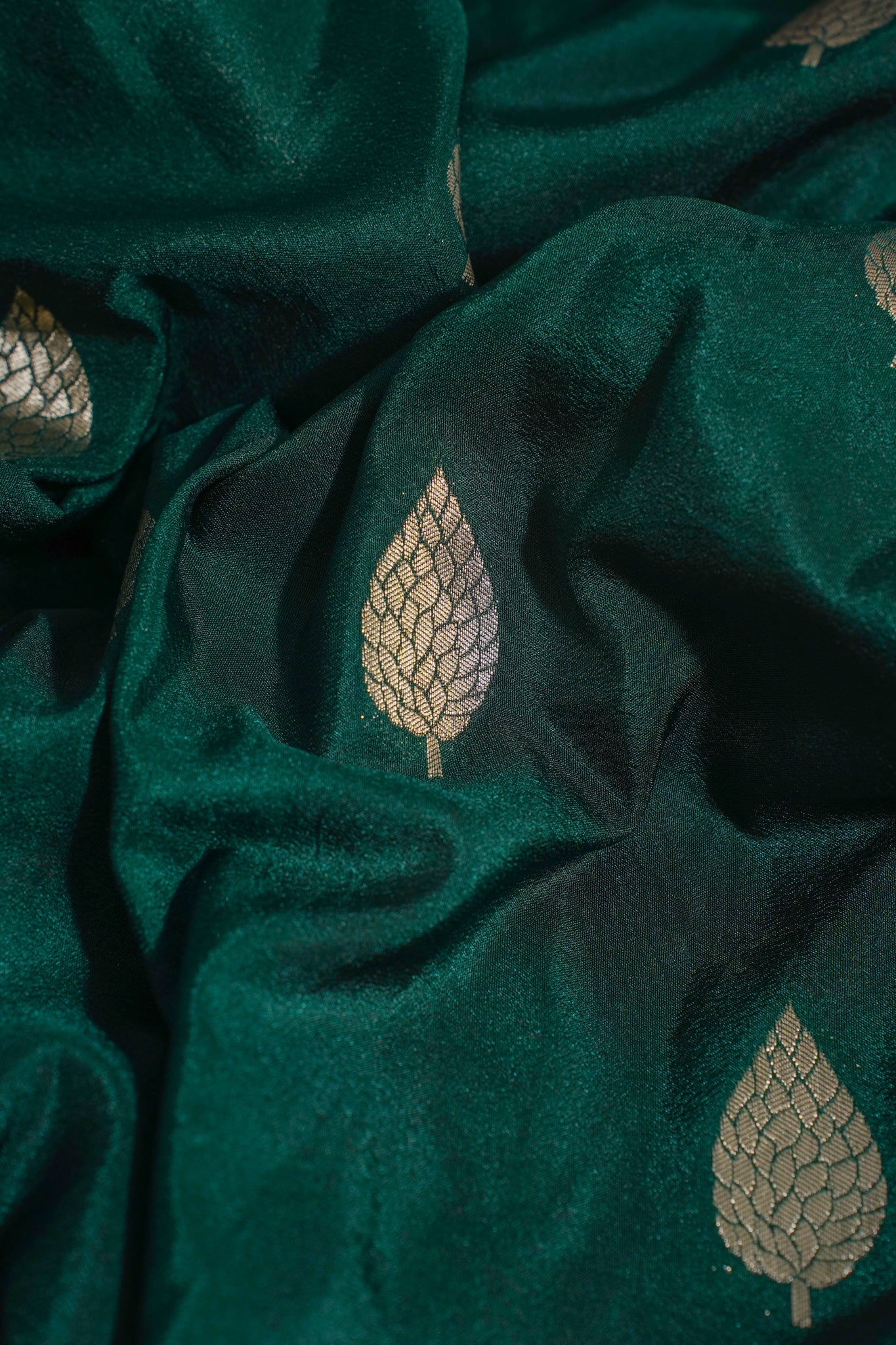Close-up of dark green fabric with leaf patterns