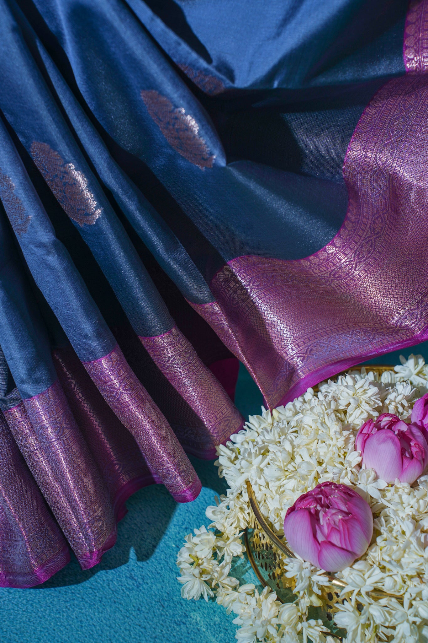 Blue and pink fabric with floral arrangement and basket on a blue background