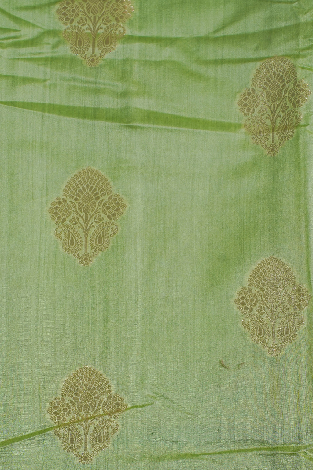 Green fabric with gold floral patterns
