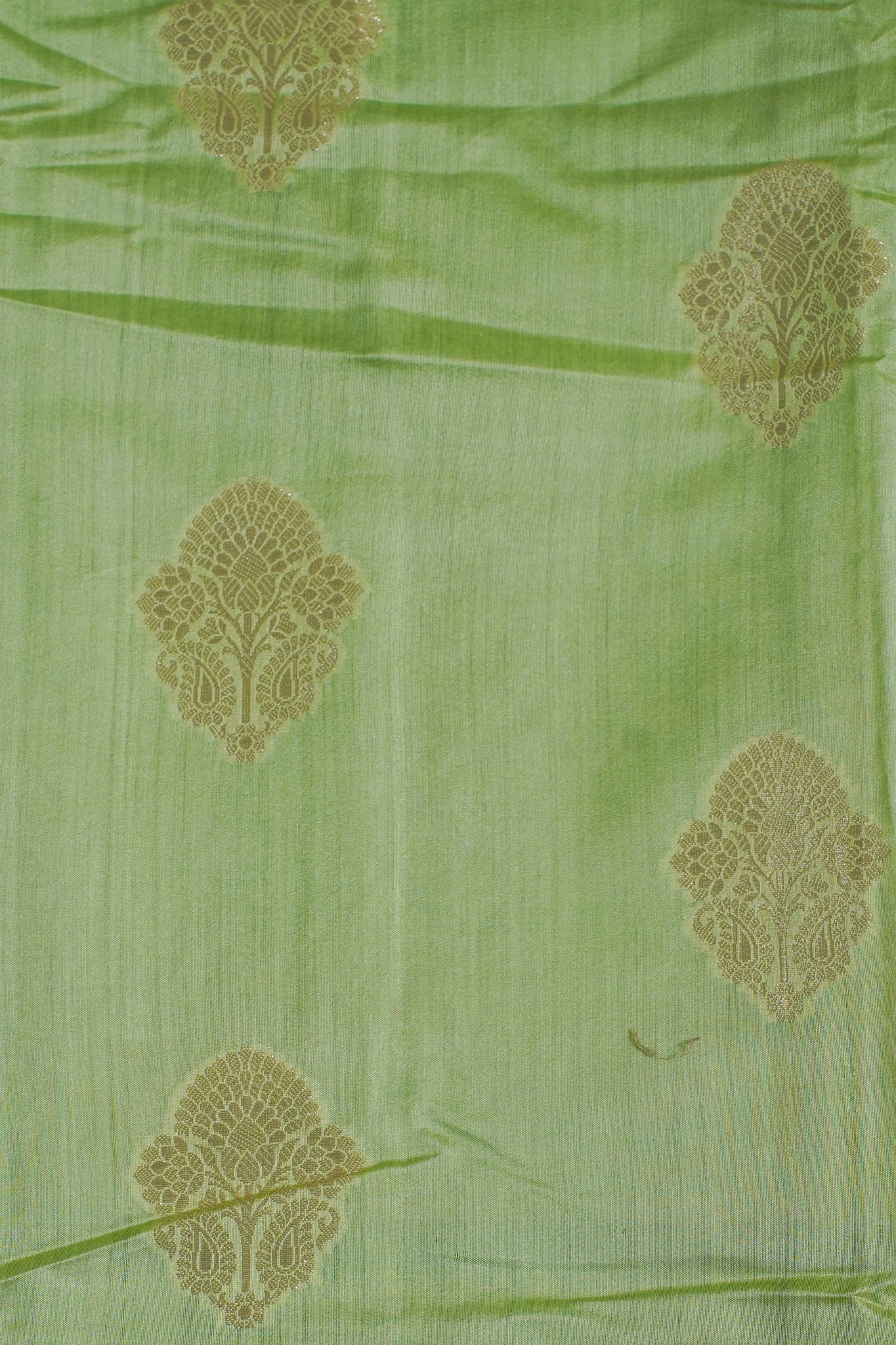Green fabric with gold floral patterns
