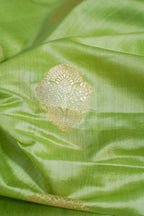 Close-up of green fabric with a gold embroidered design