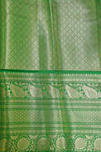 Green fabric with intricate patterns and borders