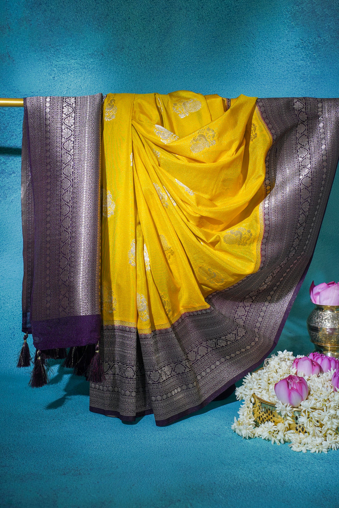 Yellow saree with purple border on a blue background