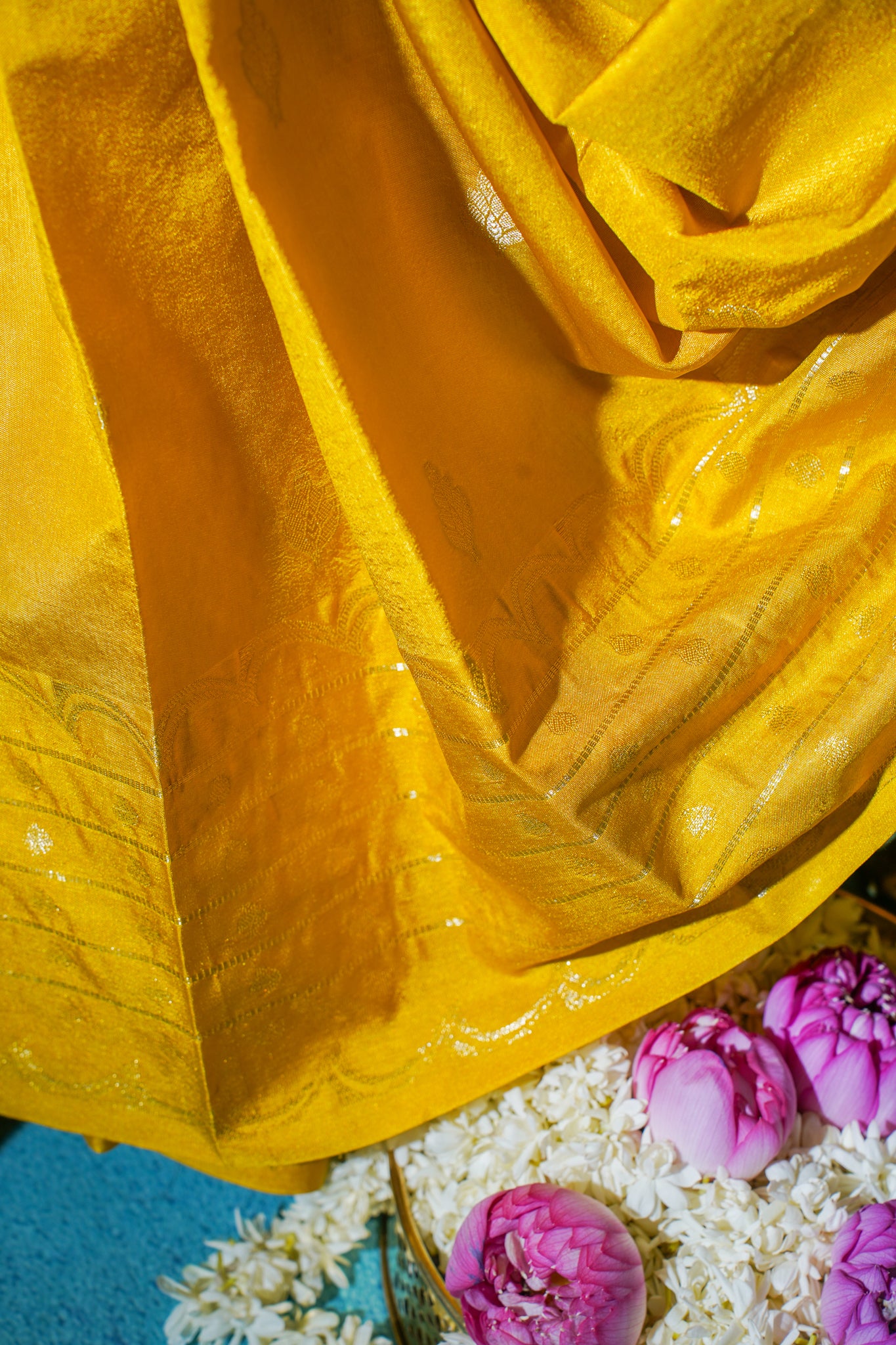 Close-up of yellow fabric with pink and white flowers at the bottom
