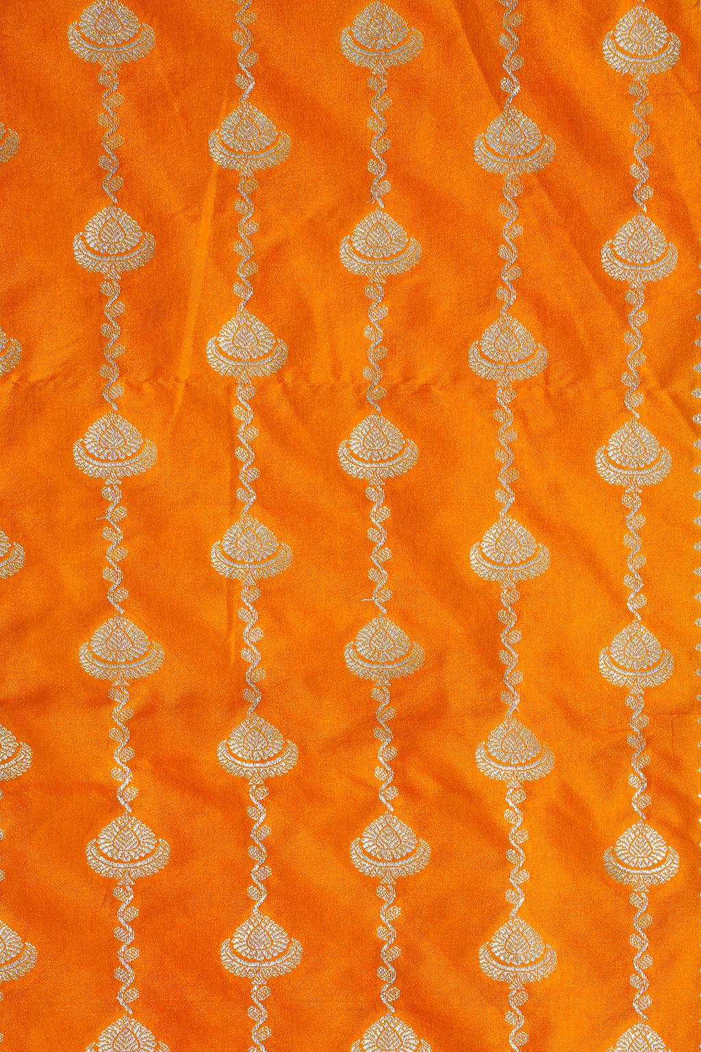 Decorative fabric with gold patterns on an orange background