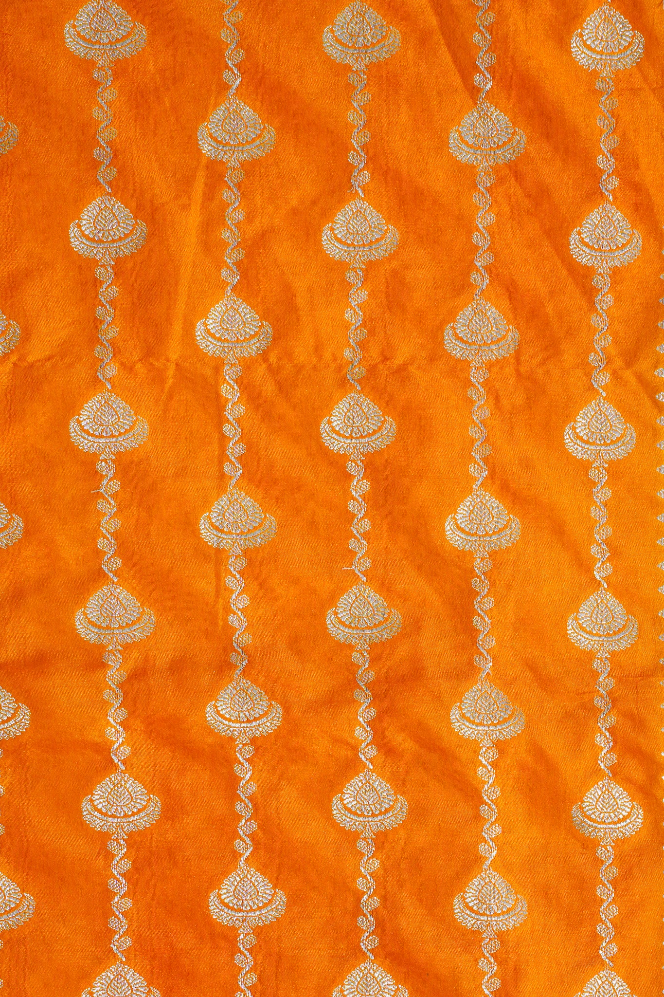 Decorative fabric with gold patterns on an orange background
