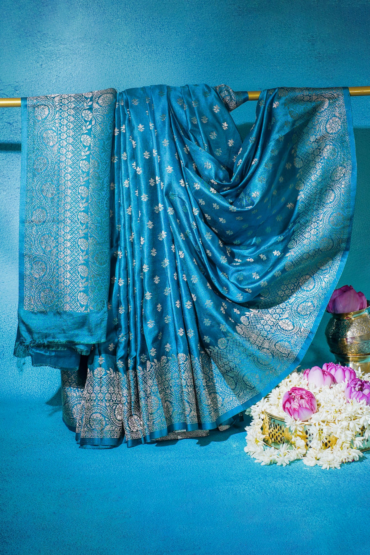 Blue saree with silver patterns on a blue background