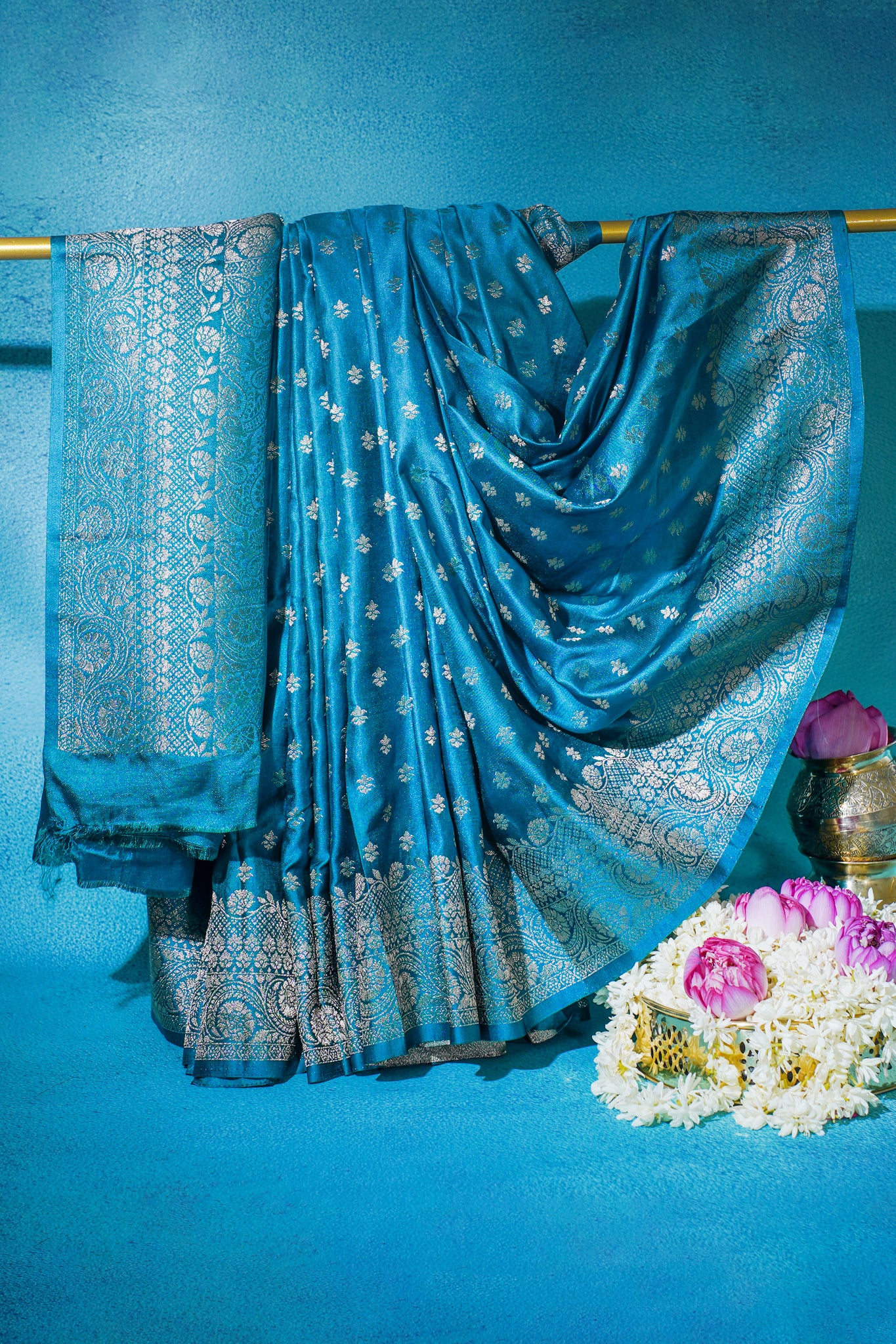 Blue saree with silver patterns on a blue background