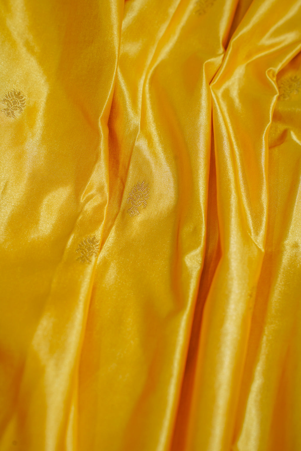 Close-up of yellow fabric with subtle patterns