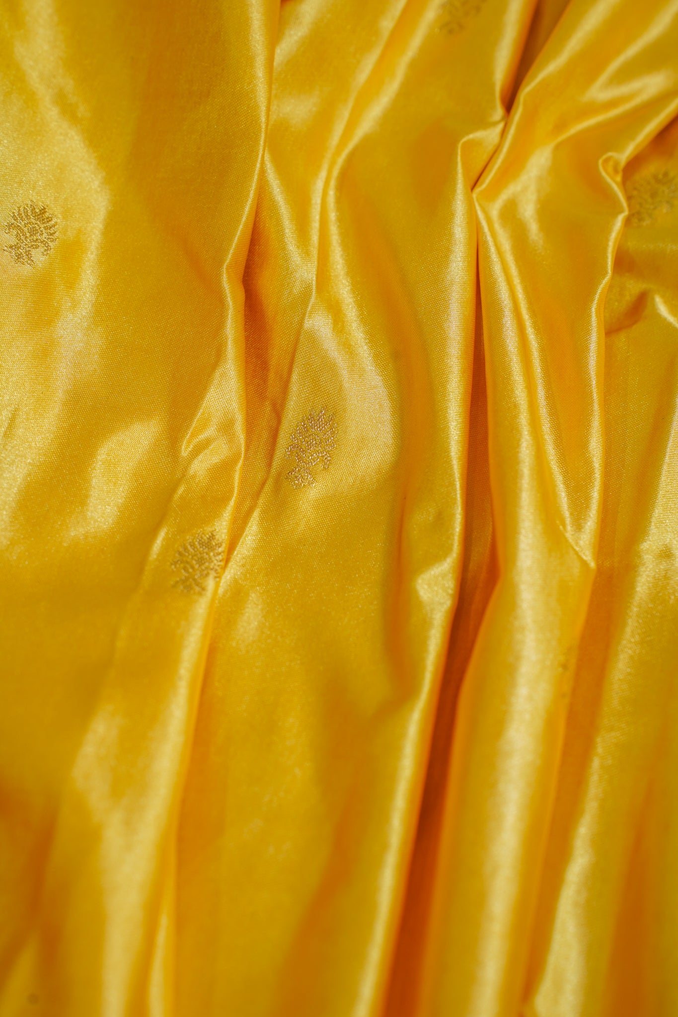 Close-up of yellow fabric with subtle patterns